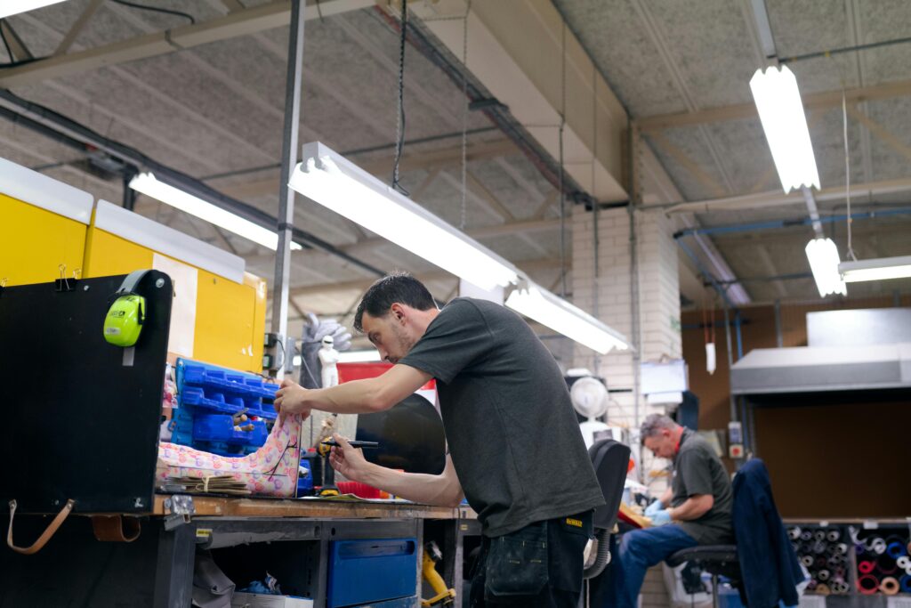 Orthotic technicians skillfully crafting and preparing orthopedic devices in a workshop setting.